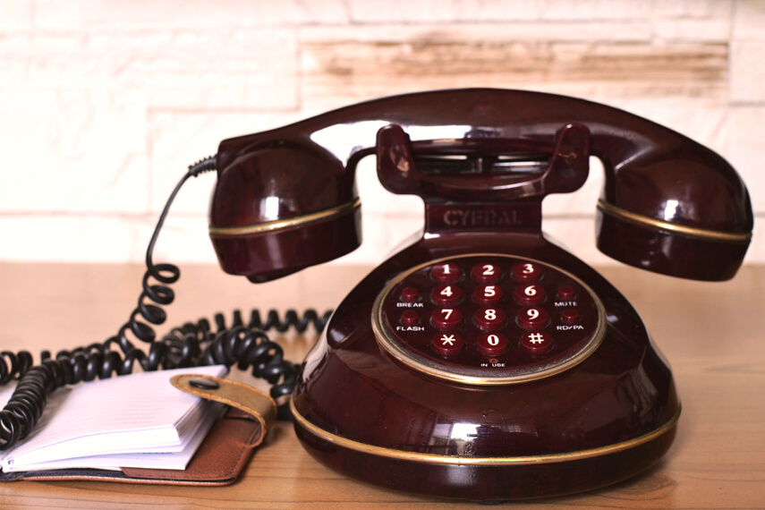 Maroon Push Button Telephone on Table